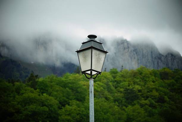 Lamp looks over misty mountains stock photo