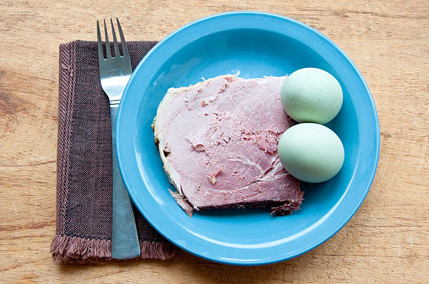 Green eggs and ham with fork, napkin stock photo