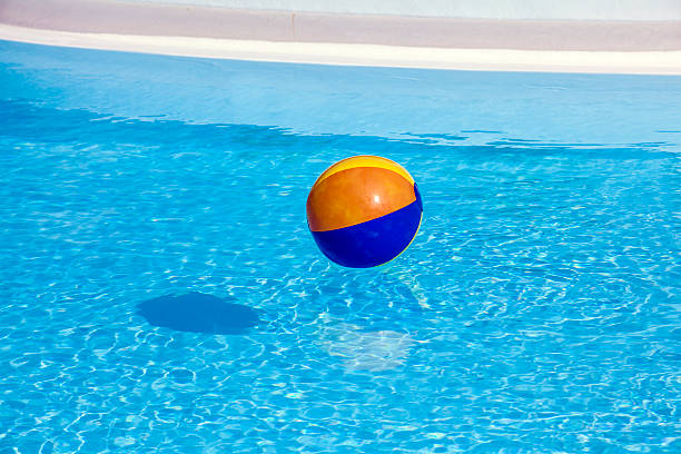 istock inflated plastic ball flying in the pool 180894796