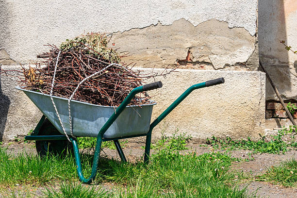 istock wheelbarrow near the old wall 180895224