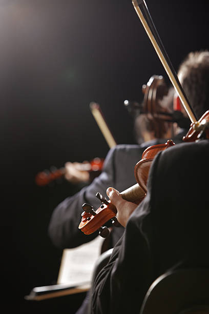 istock Violinists playing classical music live in concert 180895342