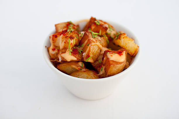 Patatas bravas typical Spanish potato tapas A typical potato dish from Spain often served as a tapas. patatas bravas stock pictures, royalty-free photos & images