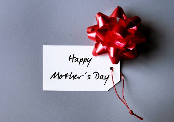 istock Red gift bow on handwritten text gift tag Happy Mother's Day, refers to celebration honoring the mother or motherhood, to thank for all she's done and wish mom happiness 1808977167