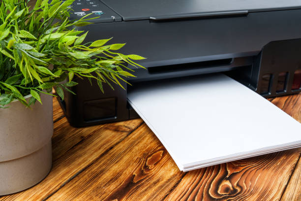 istock Modern laser printer with paper on wooden background 1808993082