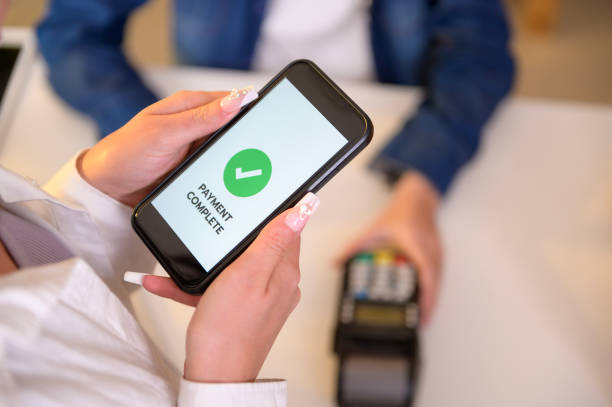 istock woman customer using QR code payment via smartphone for paying at shop 1808993099
