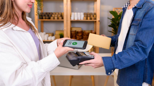 istock woman customer using QR code payment via smartphone for paying at shop 1808993614