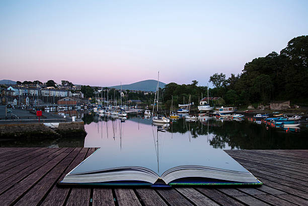 istock Creative concept book village harbour sunset landscape 180899974