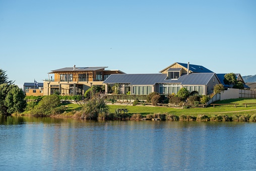 Waikanae, New Zealand – June 01, 2014: A scenic view of a beautiful modern house against the lake on a sunny day