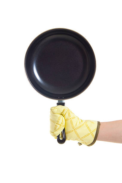 istock hand in gloves holding pan 180901067