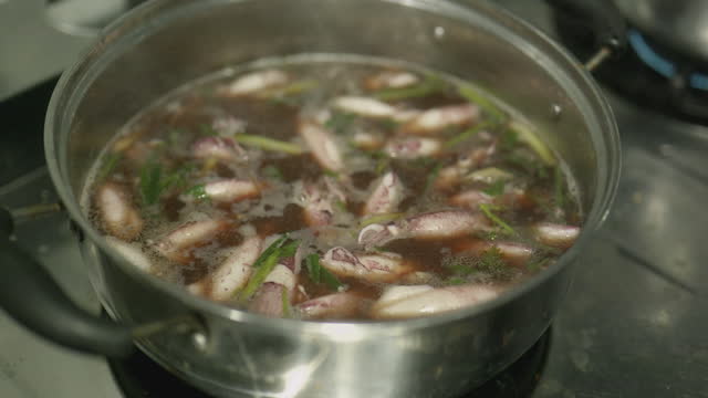 Cooking Squid boiled in black water, Thail seafood style.