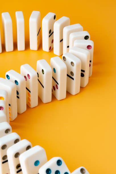 istock Row of domino tiles on yellow studio background 1809015237