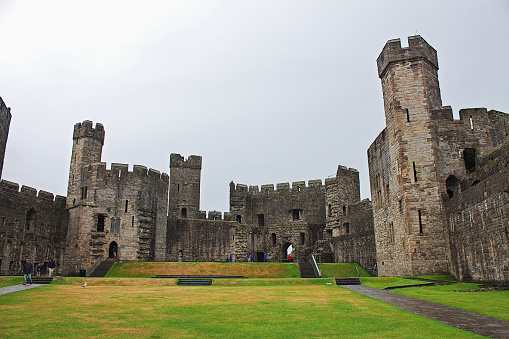 The entrance of Tonbridge Castle in Kent, England. After William the Conqueror took England at the Battle of Hastings in 1066, his kinsman Richard Fitz Gilbert was tasked with guarding the crossing of the River Medway. He built a simple Motte-and-bailey castle. The castle was later besieged in 1088 when Fitz Gilber's descendants rebelled against William's son, King William II. The king had the castle and Tonbridge burnt to the ground in revenge. By 1100, a new wooden castle was replaced with a stone shell keep and in 1295 a stone wall encircled the town. The castle was used to safekeep the great seal of England for a while when King Edward I visited France. In 1793, the mansion was built, and both buildings are now Grade I listed.