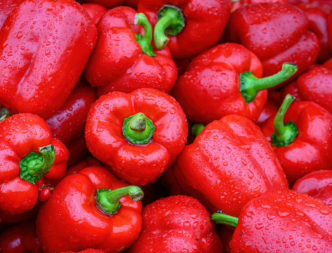 Red capsicums with raindrops in the market for sale