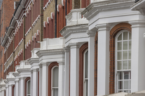 row of white edwardian houses in Kensington; London, United Kingdom