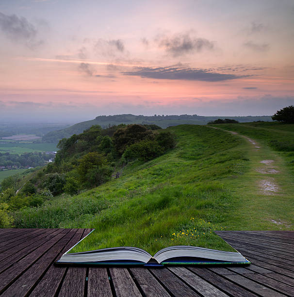 istock Creative concept book Vibrant sunrise over countryside landscape 180904472