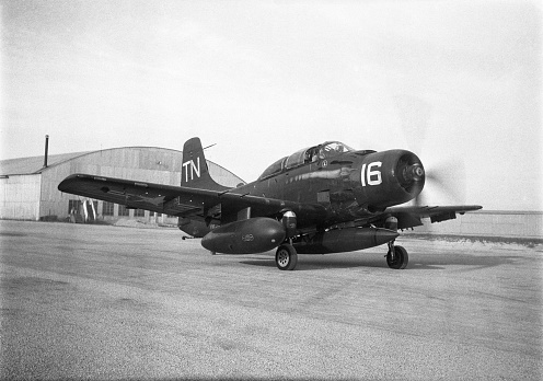 Douglas AD-5N Skyraider dive bomber with extra fuel tank and torpedo taxiing. Photo taken in 1953.