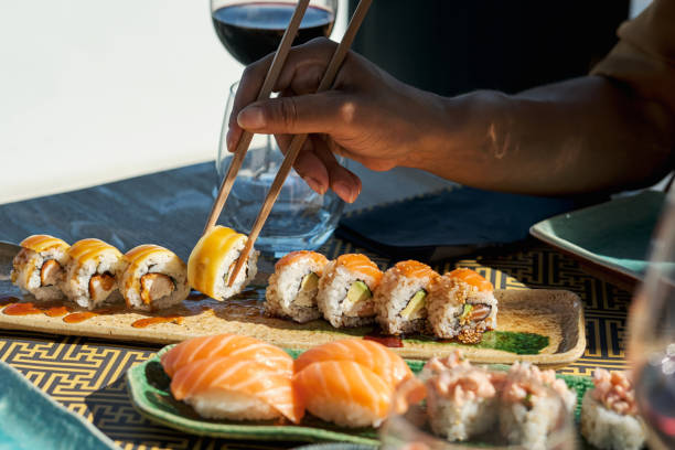 istock Faceless person eating sushi and rolls 1809051638