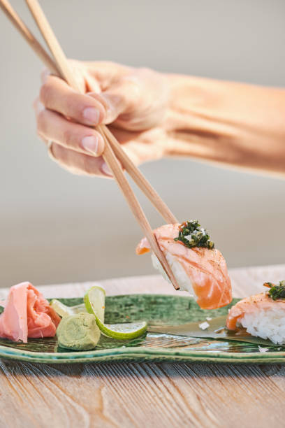 istock Unrecognizable person eating sake nigiri sushi 1809051774