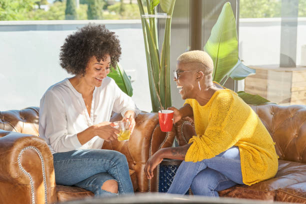 istock Cheerful diverse women having fun on sofa at home 1809052806