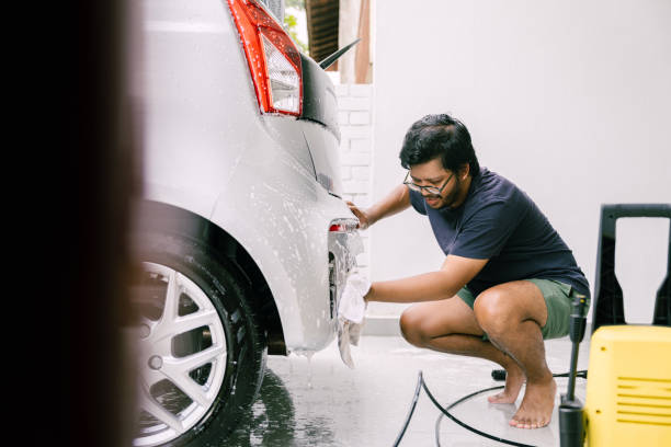 istock Young Man Cleaning His Car with Soap, Car Washing 1809064237