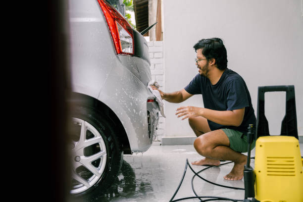 istock Young Man Cleaning His Car with Soap, Car Washing 1809064239