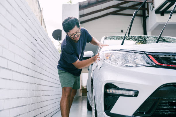 istock Young Man Cleaning His Car with Soap, Car Washing 1809064757
