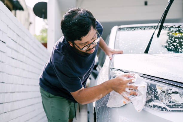 istock Young Man Cleaning His Car with Soap, Car Washing 1809064758