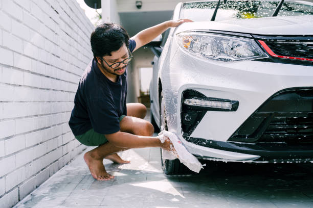 istock Young Man Cleaning His Car with Soap, Car Washing 1809064761