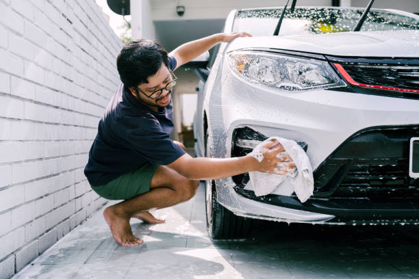 istock Young Man Cleaning His Car with Soap, Car Washing 1809064762