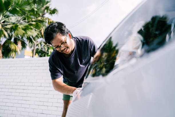 istock Young Man Cleaning His Car with Soap, Car Washing 1809064768