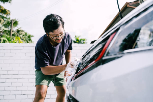 istock Young Man Cleaning His Car with Soap, Car Washing 1809064769