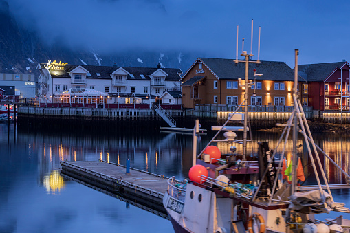 Svolvaer , Norway - April 20, 2023: fishing boats in the harbour of Svolvaer on the Lofoten Islands at dusk