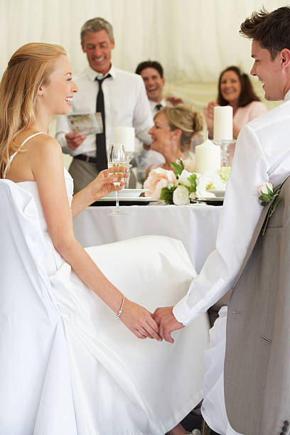 istock Bride And Groom Listening To Speeches At Reception 180907723