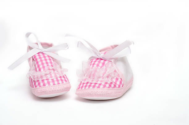Blue knitted baby booties and a nappy pin with copy space