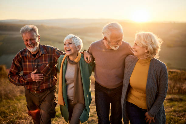 istock Happy mature couples talking while walking in autumn day. 1809086205
