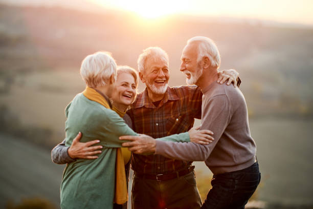 istock Happy embraced friends talking in nature at sunset. 1809088271