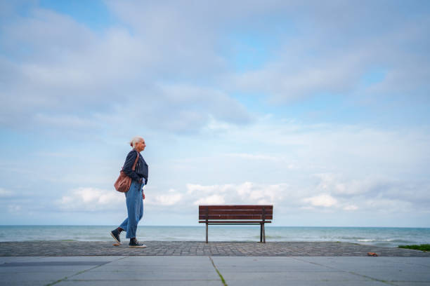 istock Woman walking at sea side public park 1809088809