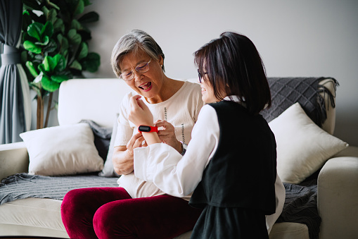 Asian Chinese grandmother bought granddaughter a smart watch for her protection.