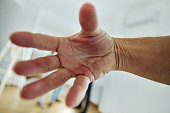 Close up of man's palm touching camera.