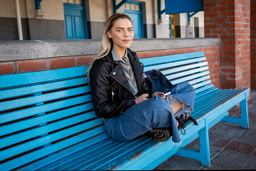 istock Attractive young woman waiting for the train at railway station 1809118838