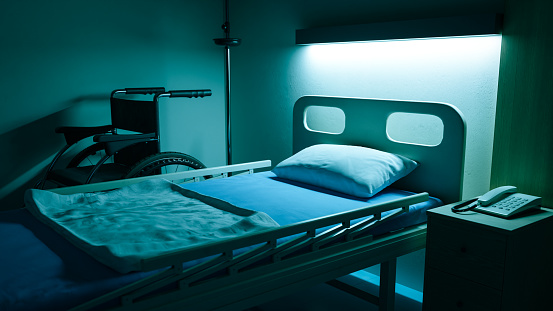 an inpatient bed with only a light above the head of the hospital at night,3d rendering