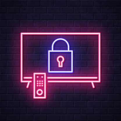 istock TV with padlock. Glowing neon icon on brick wall background 1809120459