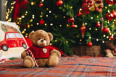 Teddy bear on bed with pillows for Christmas decoration