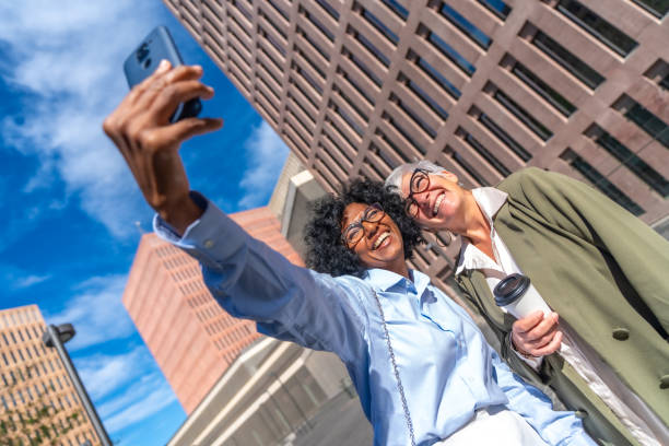 istock Multicultural businesswomen taking a selfie smiling at camera outdoors 1809132000