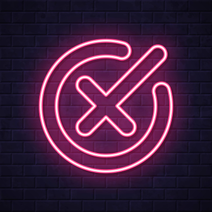 istock Cross mark. Glowing neon icon on brick wall background 1809134165