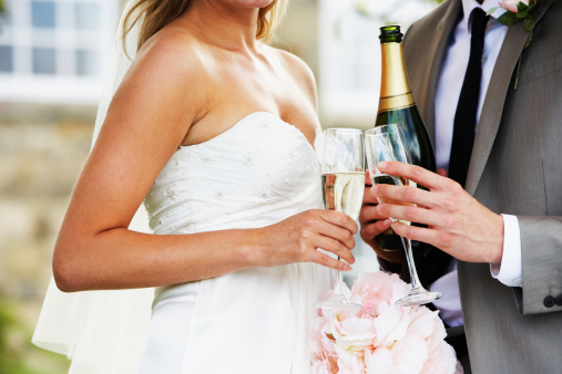 Detail Of Bride And Groom Drinking Champagne At Wedding