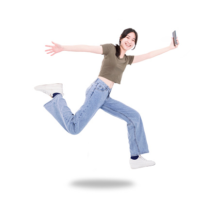 Happy girl student hold mobile phone jump and run wear t-shirt denim isolated white background