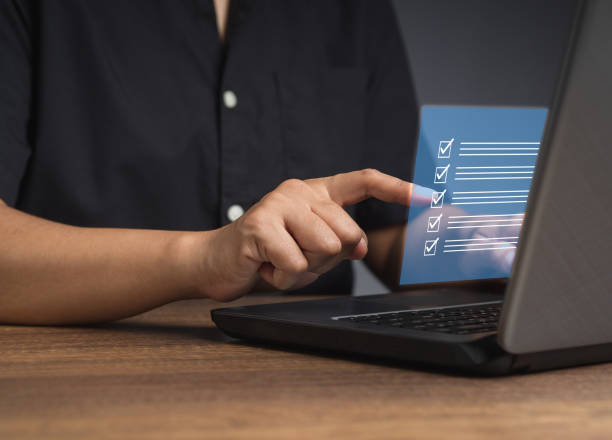 istock Businessman touching a checkmark symbol on a document management system or DMS on a virtual screen 1809149053
