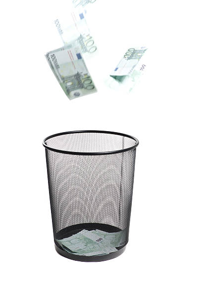 istock money flying into the trash 180915162