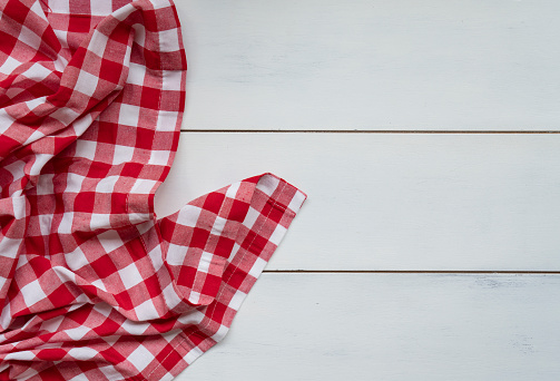 Red checked tablecloth on wooden